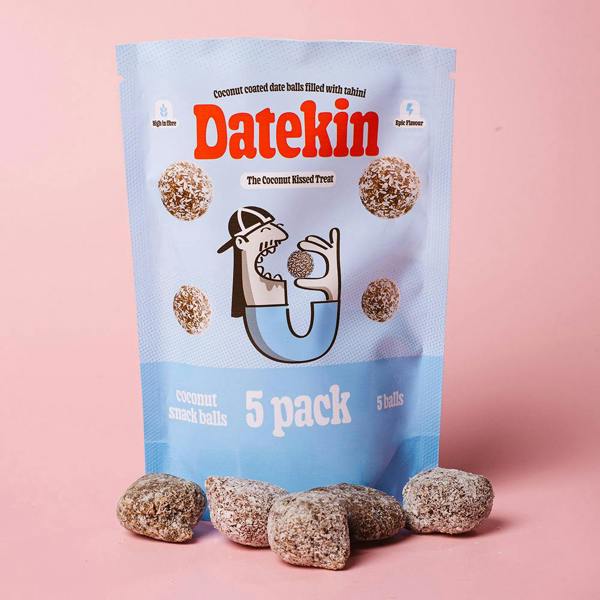 Blue packaging of Datekin coconut date balls with date balls surrounding the bottom with a pink background