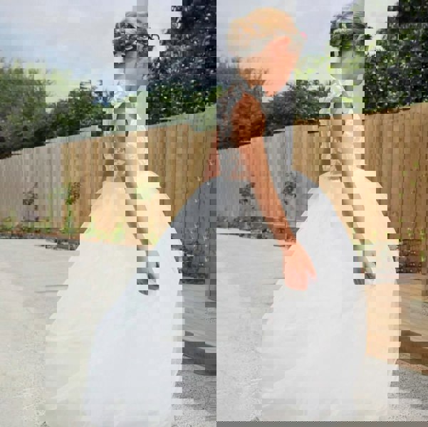 girl wearing a long white flower girls dress