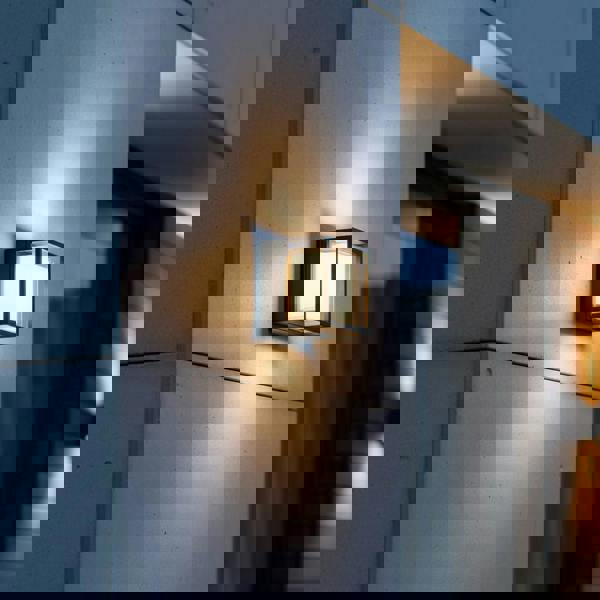 black square outside wall light mounted on the exterior concrete wall of a modern home 