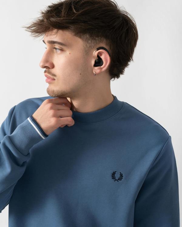 close up shot of a model wearing a Fred Perry Mens Crew Neck Sweatshirt in Ace Blue with Snow White & Tennis Blue trim