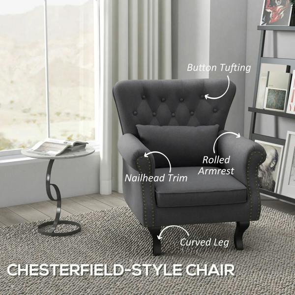 Dark grey Chesterfield-style accent chair with button tufting and nailhead-trim arms