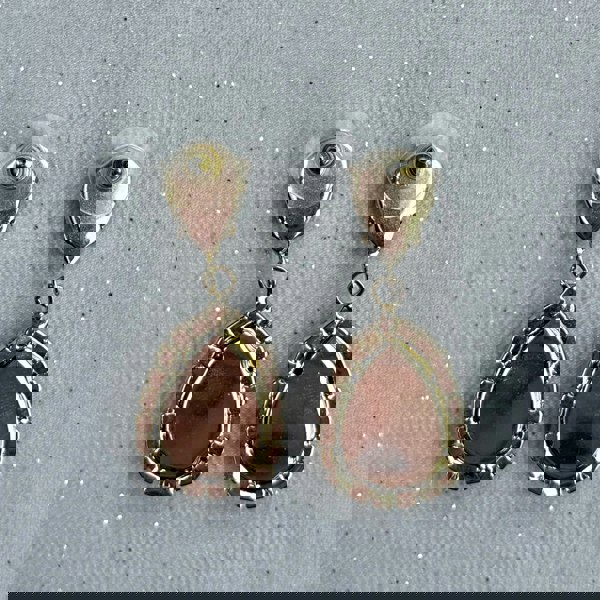 Gold drop earrings, teardrop shape, polished metallic finish, textured beaded edge detailing, statement jewellery design, vintage inspired style, elegant accessory for evening wear or gift for her
