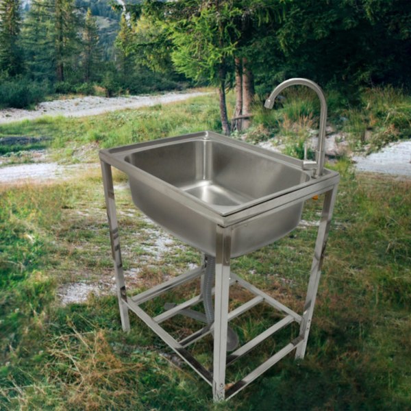 Portable stainless steel camping sink with a sleek design, sturdy frame, and faucet, set against a natural outdoor backdrop