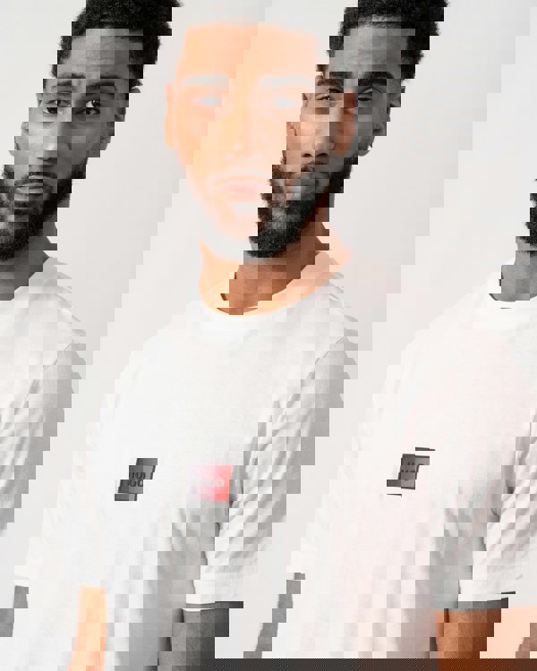 close up of a model wearing a HUGO Danotie Mens Red Label Logo T-Shirt in natural white