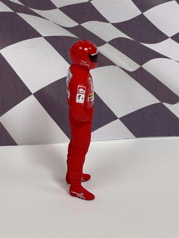 a toy figure in a red suit