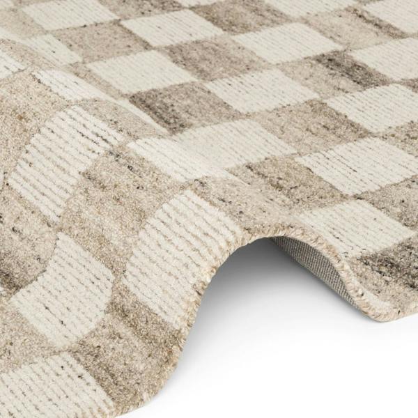 Close-up of a textured beige and white checkered rug