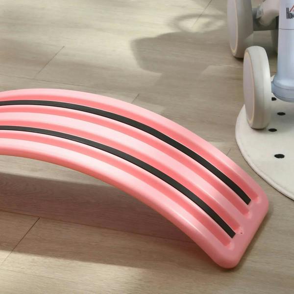 Pink balance board underside with black anti-slip grip stripes
