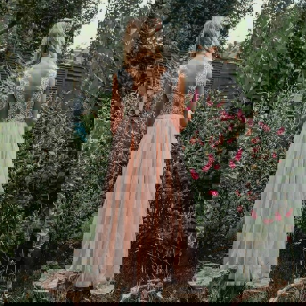 young flower girl in garden wearing a Bohemian Classic Dress in Blush