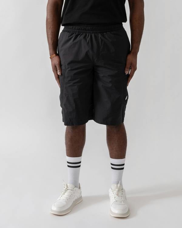 Model wearing Moose Knuckles Topflight Mens Cargo Shorts in Black 292 - front