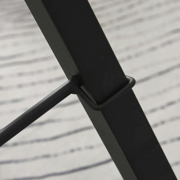 Black steel support bar on gravity inversion table frame, close-up