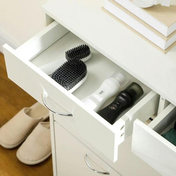 White shoe cabinet flip drawer open with brush and shoe care bottles inside