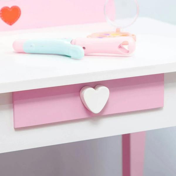 Kids pink vanity drawer with white heart handle on the dressing table