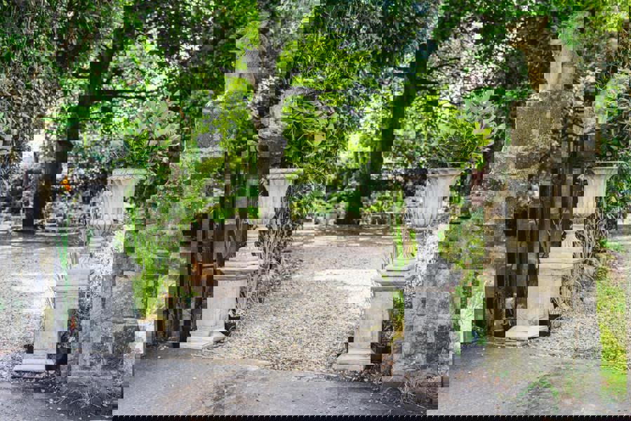 Pair of Large Stone Cast Flute Urns and Classic Plinths