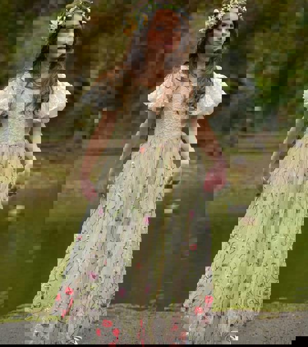 young girl smiling holding dress