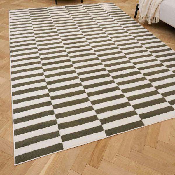 Checkered green and white rug on a wooden floor