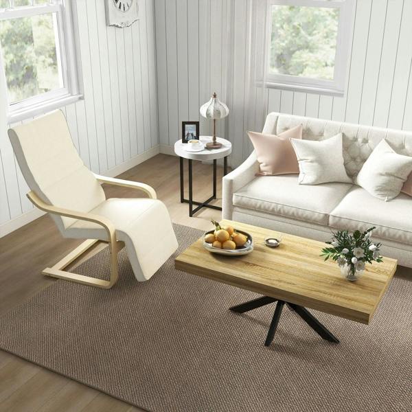 Cream upholstered lounge chair with light wood base in a bright room by windows
