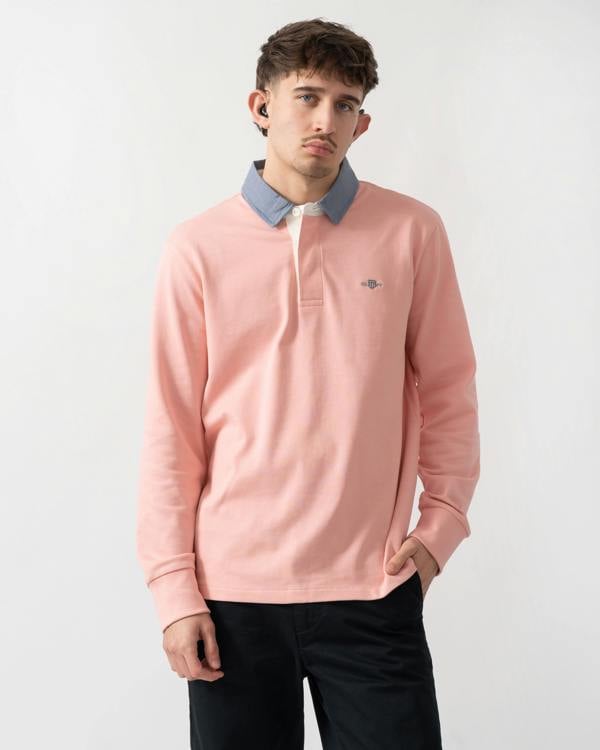 studio shot of a model wearing a GANT Mens Regular Fit Chambray Heavy Rugger in Bubblegum Pink