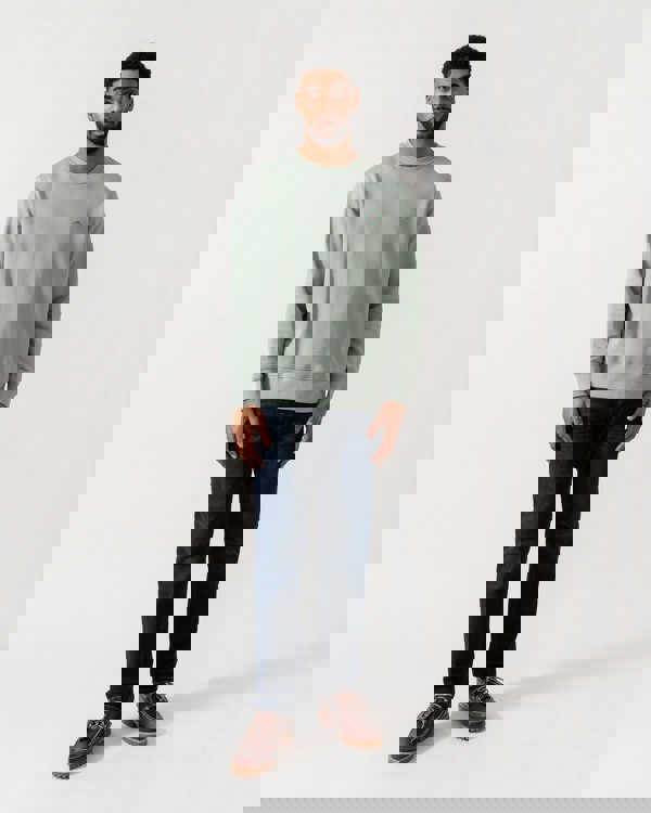 Model wearing GANT Mens Regular Fit Shield Logo Crew Neck Sweatshirt -in 10 Ceramic Grey -  full length