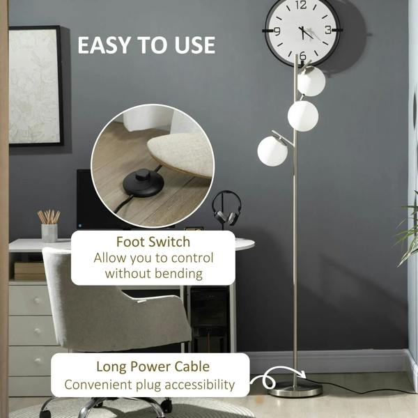 Silver floor lamp with three white globe shades and visible power cable