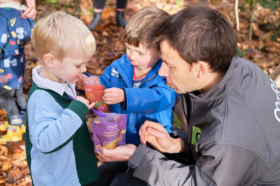 Dad and two toddlers preparing a more toddler meal. 