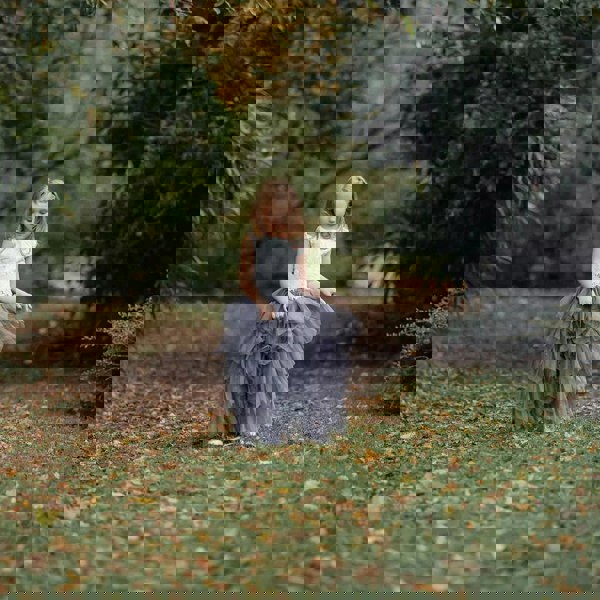 flower girl holding her skirt