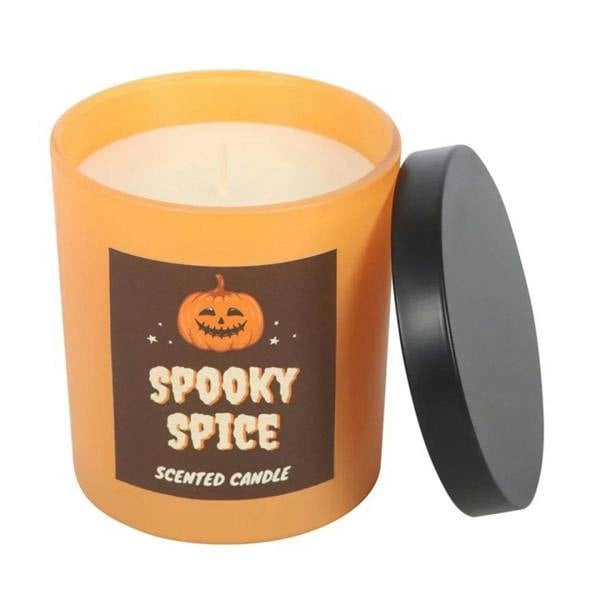 Scented candle in orange glass jar with printed spooky pumpkin label and black lid