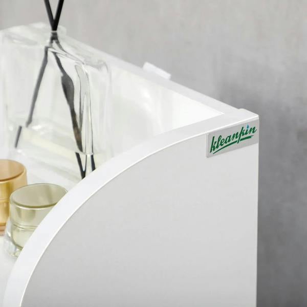 White cabinet with curved top edge and small brand label on the door