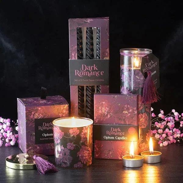 Set of 6 Opium tealight candles with floral packaging and multiple lit flames