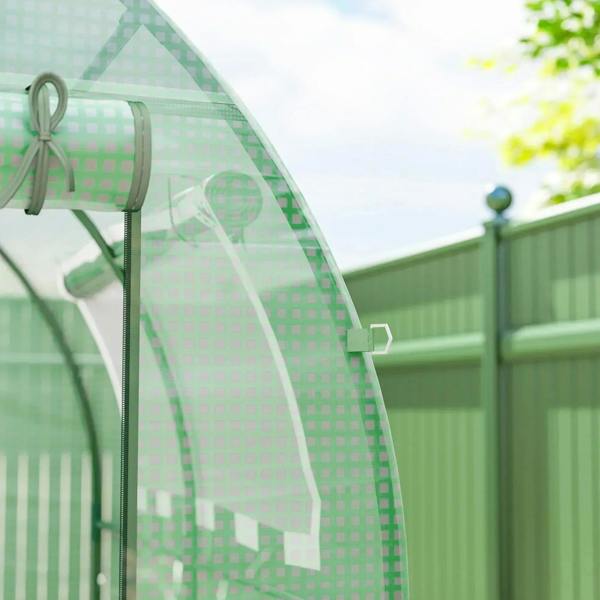 Green greenhouse roll-up window panel on curved frame with metal support