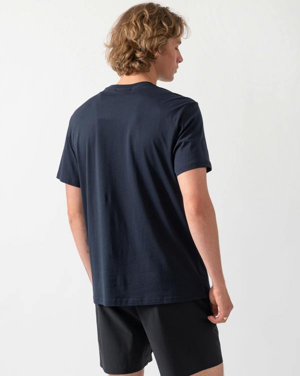 back shot of a model wearing an Emporio Armani Mens Beach T-Shirt with Eagle Logo in Armani Blue