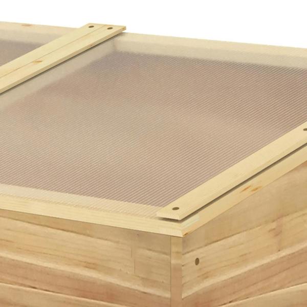 Wooden cold frame greenhouse close-up of clear ribbed polycarbonate top panel