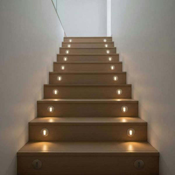 silver recessed step light installed in the stair risers of a modern staircase
