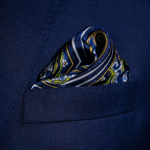 Labyrinth paisley silk pocket square in blue and white with lime green and orange by Otway & Orford folded in top pocket