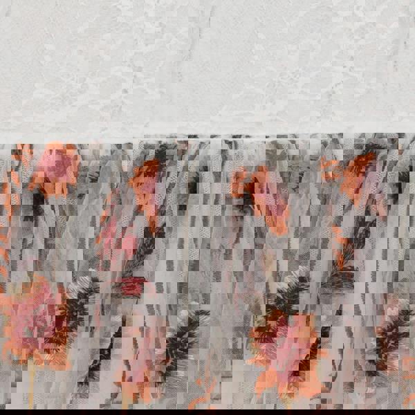 Sheer fabric with floral pattern on a textured white background