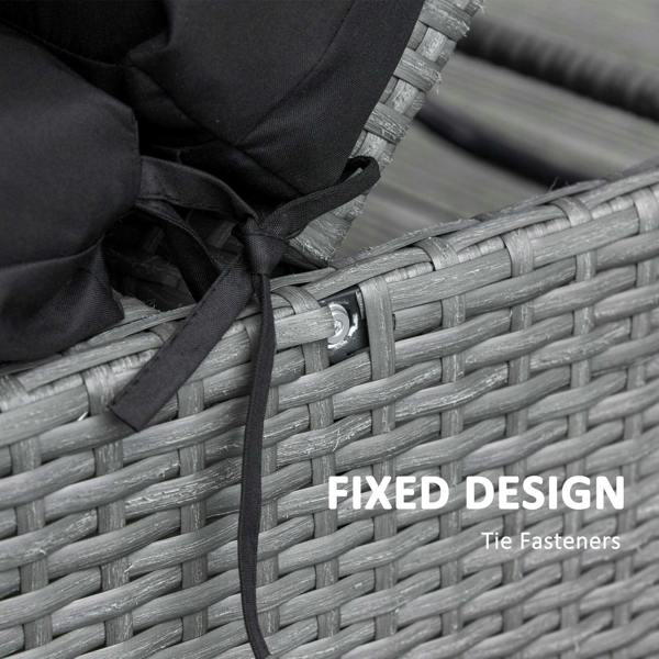 Black cushion tie strap secured to wicker chair frame with metal fastener