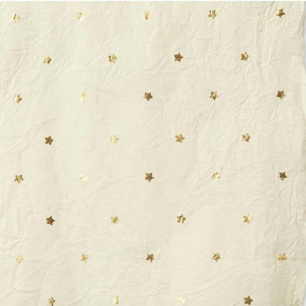 Close-up texture of warm white handmade recycled cotton wrapping paper featuring a repeating gold foil star pattern.