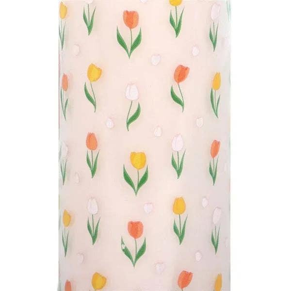 Close-up of tulip print on frosted glass candle jar