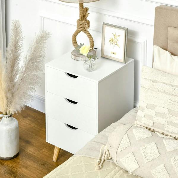 White bedside cabinet with three drawers and black curved pulls on pine legs