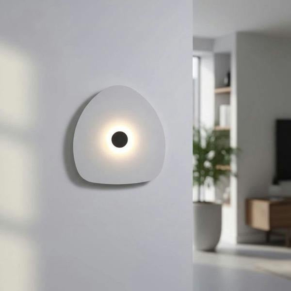 Modern internal wall light white finish with a black halo dot to the centre in a modern home setting