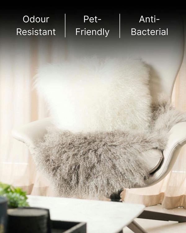 White mongolian sheepskin pillow on single chair