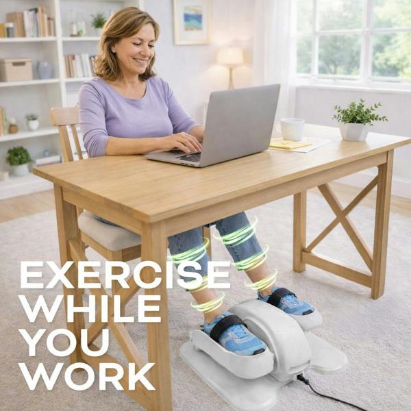 A woman works at her desk on a laptop, using the Reviber Motorised Mini Elliptical Bike for seated exercise. "Exercise While You Work" appears overlaid, with green motion lines showing leg movement in a bright home office. Brand: Reviber.