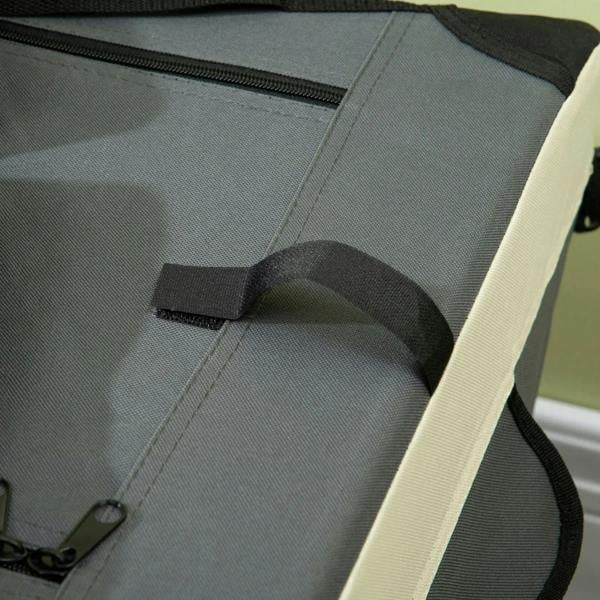 Close-up of rolled grey cushion mat inside foldable pet carrier with securing straps