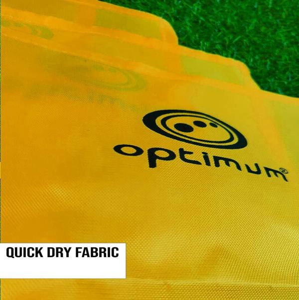 Close-up of yellow Optimum corner flag fabric with black logo on grass, Quick Dry Fabric text - Optimum