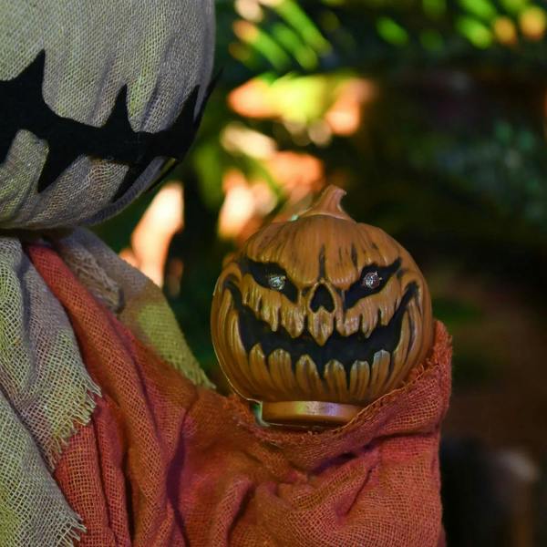 Glowing jack-o-lantern lantern with carved grin and red light inside