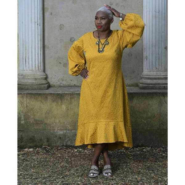 Women's Plus Size Gold Aphrodite Leopard Jacquard Dress styled with a yellow stone necklace and gold Kurt Geiger sandals for an elegant look.