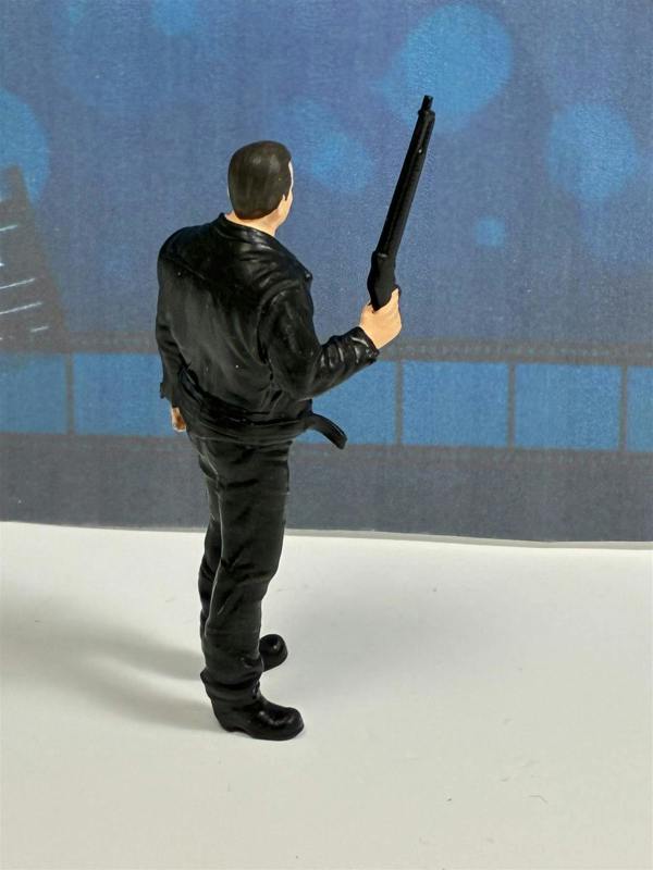 a toy figure of a man holding a gun
