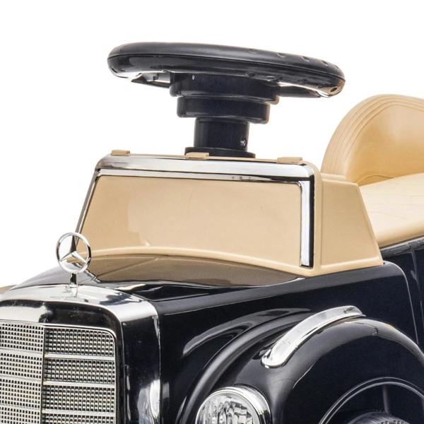 Front view of black Mercedes-Benz 300S ride-on car with beige steering console