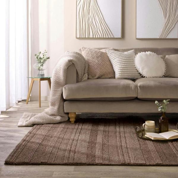 Beige sofa with decorative pillows in a living room setting