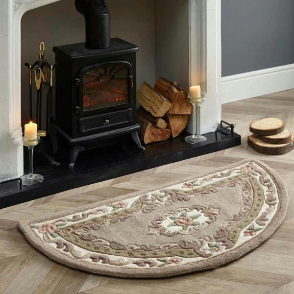Decorative half-circle rug in front of a lit wood stove with candles and firewood.