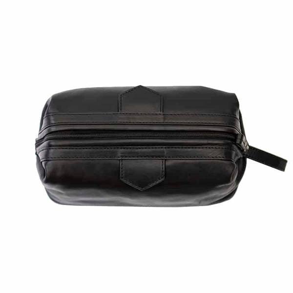 Top view of Black leather washbag on a white background
